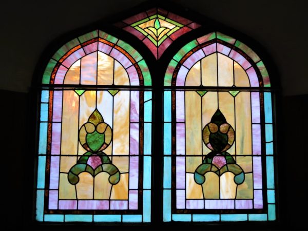 Two pains of stained glass window from the inside.