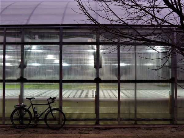 Greenhouse with a bicycle in front during a tour ride.