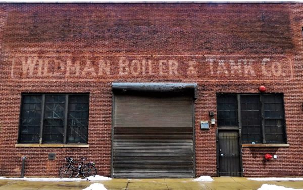 A defunct business sign with a bicycle during tour ride.