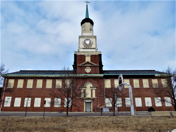 American colonial style building with clock tower and bicycle in front.