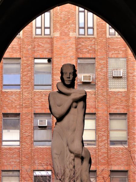 Art sculpture with brick building backdrop