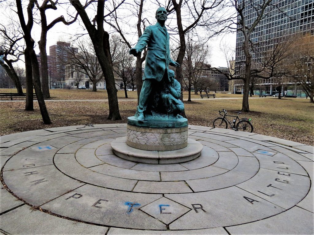 Illinois governor statue in the park with a bike during a tour ride.