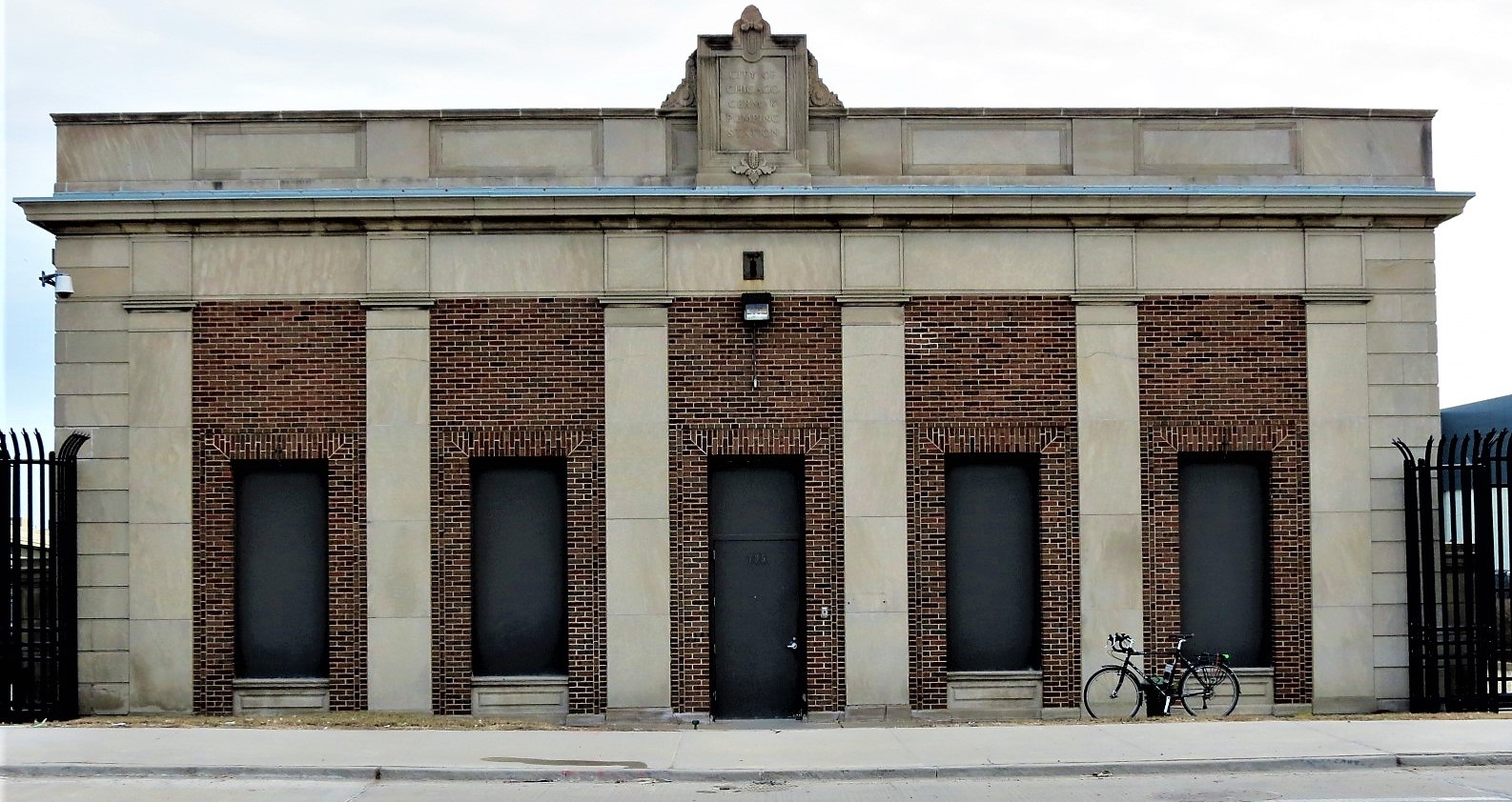 A tour bicycle leaning on red brick white stone Cermak Pumping Station