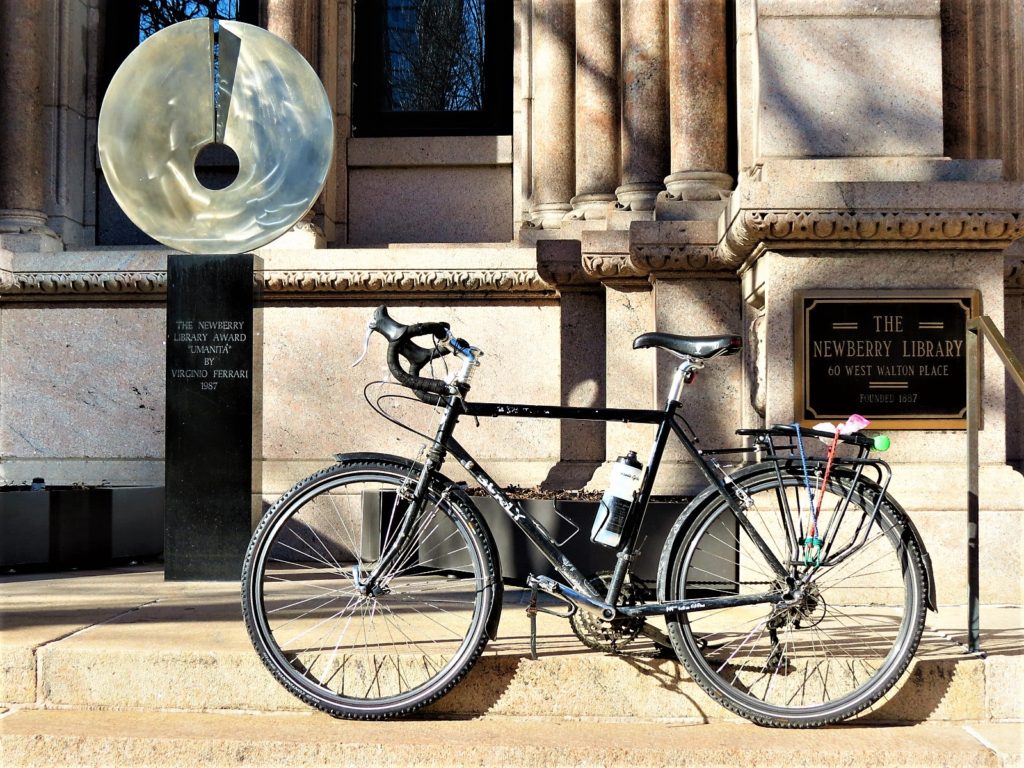 Metal disk on pedestal with a bike during a tour ride.