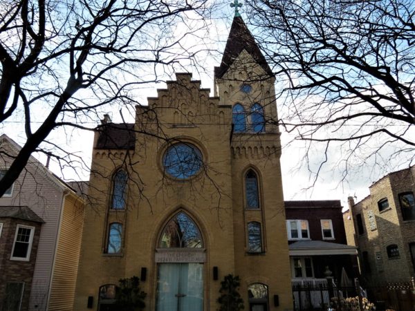 Yellow brick three story narrow former Trinity Danish Lutheran Church, today a single family home.