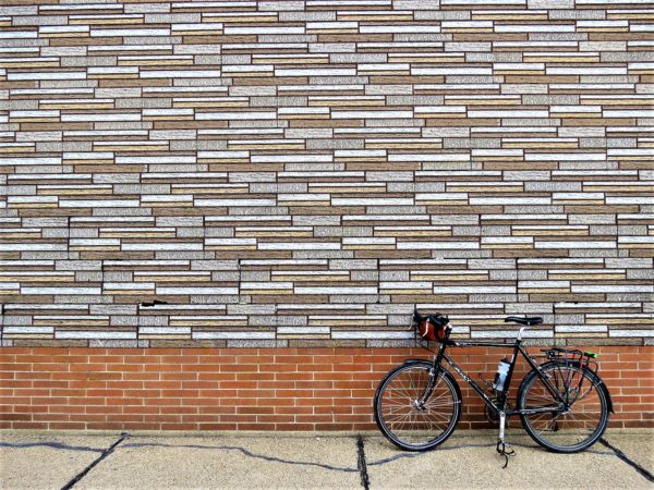 Fake brick siding with a bike during a tour ride.