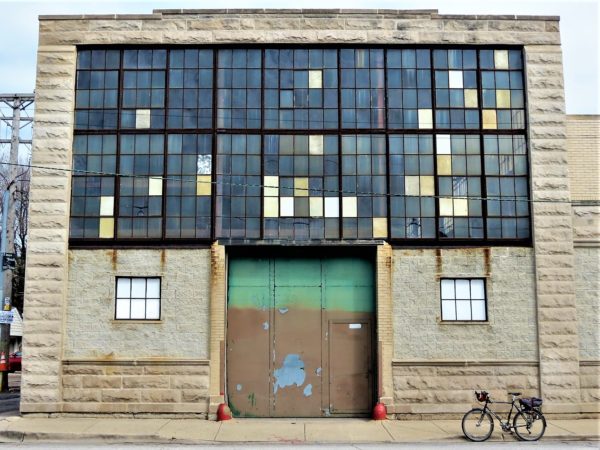 Industrial shop with window facade and a bike during a tour ride.