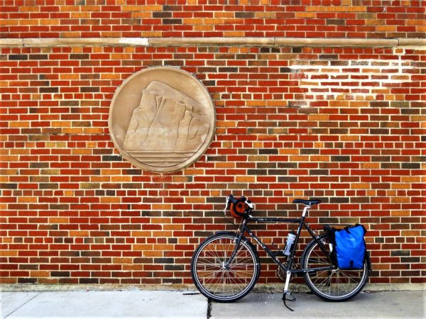 Prudential logo on a mid-century modern wall with a leaning tour bicycle.