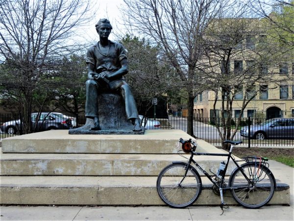 A tour bike in front of a statue of a sitting Lincoln.