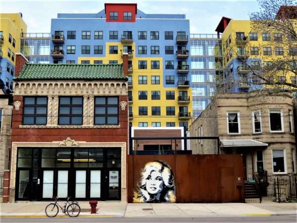 Dolly Parton mural with new and old buildings during a bike ride tour.