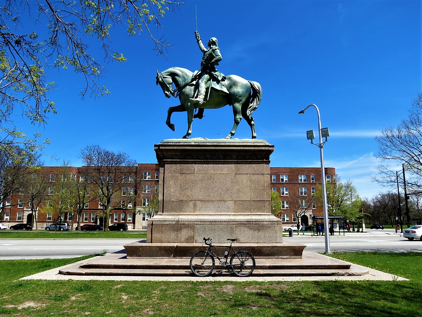 Tour bike leaning on the base of an equestrian George Washington statue