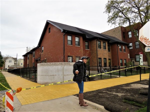 A CBA riders looking at a yelloe brick sidewalk construction in progress