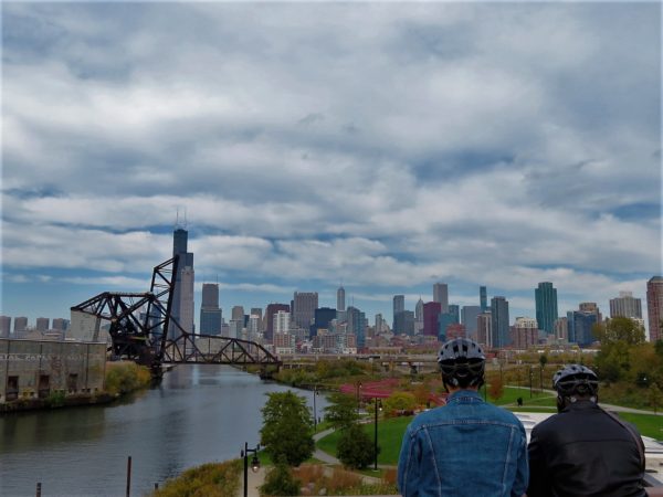 CBA bike riders looking at the Chicago skyline with the Chicago River and movable bridges in the foreground.