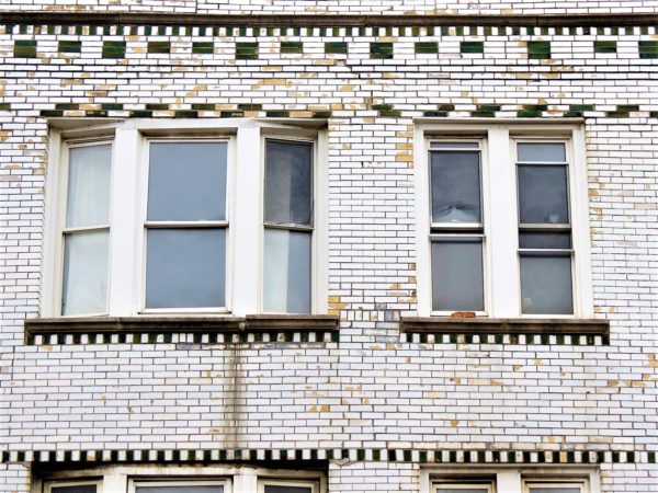 A close up of green on white glazed brick detail.