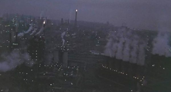 Movie still from the Blues Brothers of smoke stacks at dawn