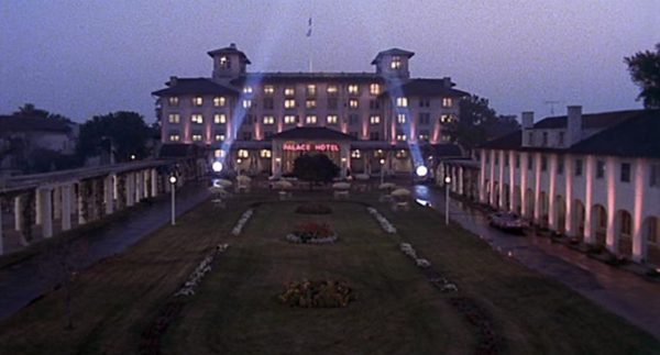 A Blues Brothers movie still of the Bluesmobile driving in the large columned courtyard of the five story Mediterranean Style Palace Hotel