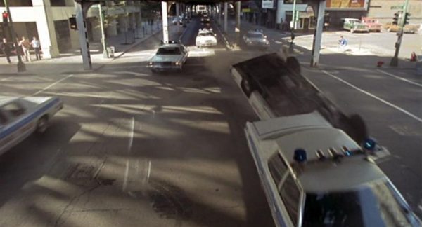 A Blues Brothers movie still of crashing police cars under elevated train tracks.