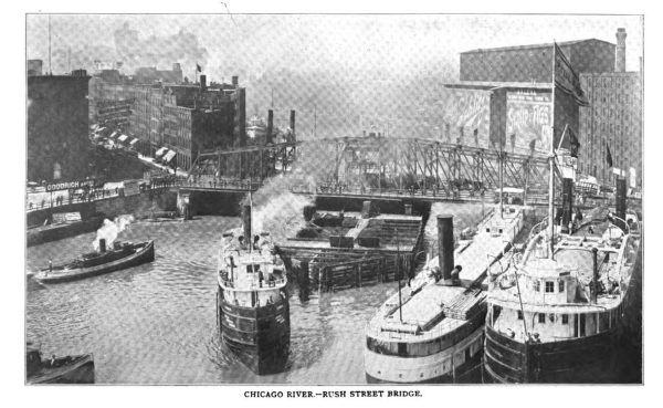 A hiatorical black and white of a swing bridge spanning a ship crowded river.