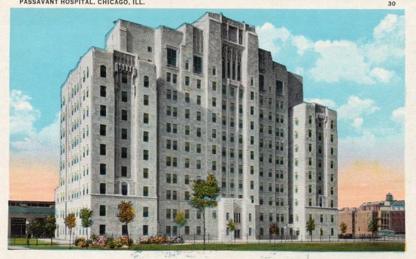 A vintage postcard showing a miltistory white marble art deco hospital building