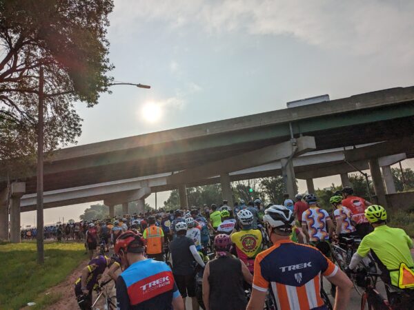 A crowd of bike riders standing with their bikes.