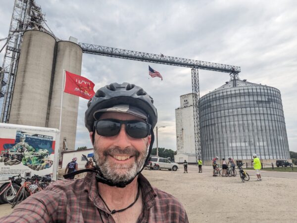 Me with a grain elevator behind that straddles the road.