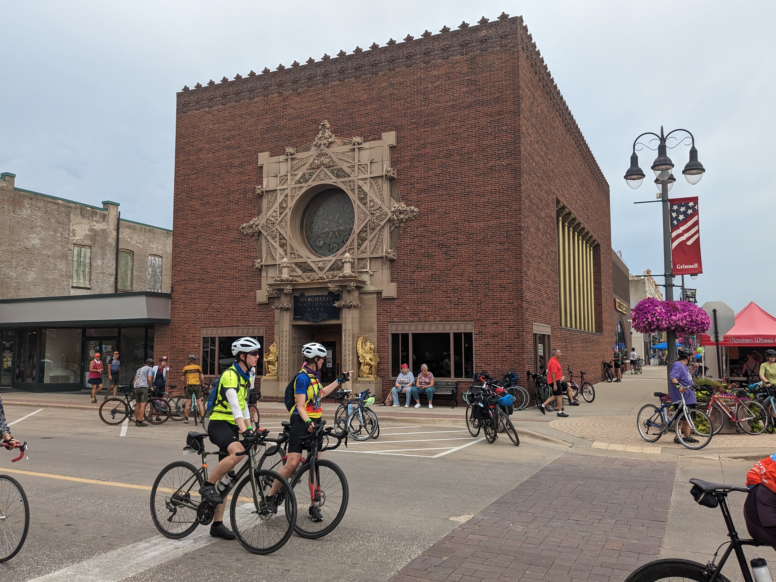 Louis Sulllivan's "Jewel Box Bank", a brown brick corner lot box with roofline brown terra cotta Sullivanesque crenulation and a grand limestone organic design entryway and occulus. 