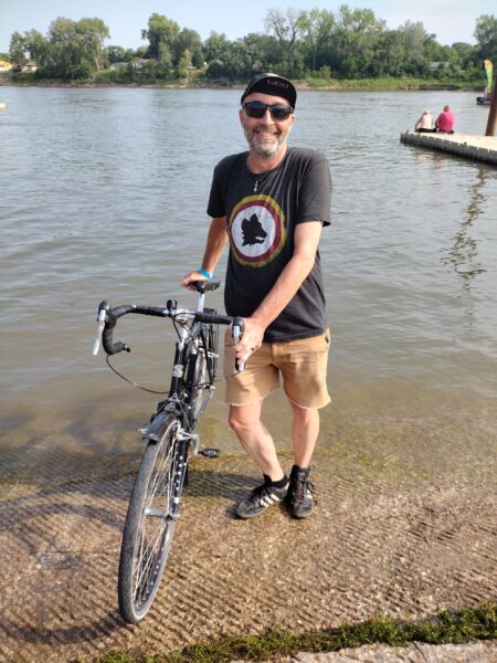 Me and my bike with its back tire in the Missouri River.