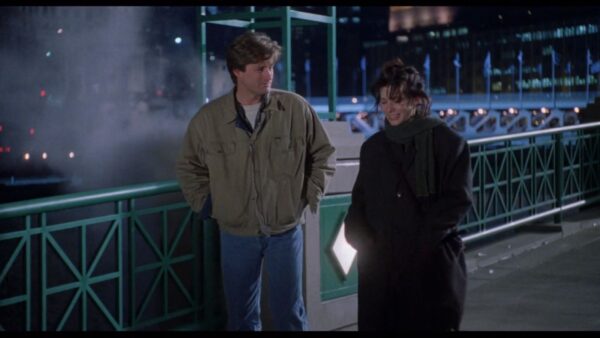 A movie still of Sandra Bullock and Bill Pullman walking.