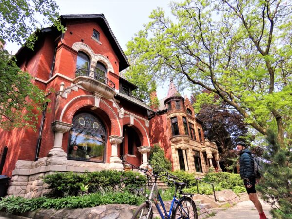 A CBA bike our rider looking at two late 19th Century three story brick Queen Anne single family homes