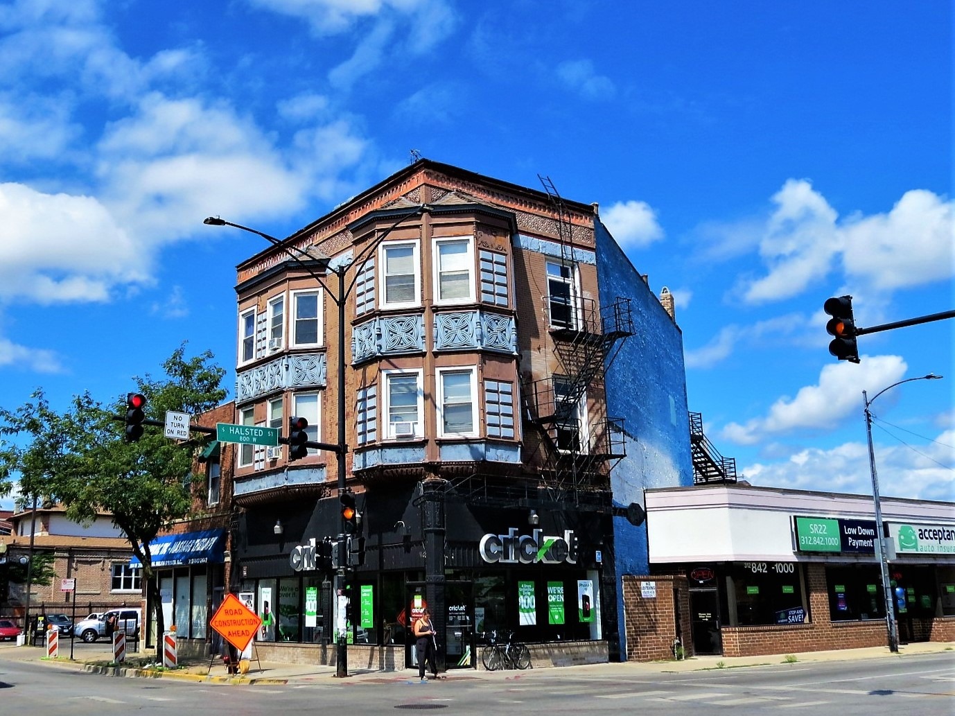 A tour bike leaning on a late 1800s corner three story storefront and flats with Gaelic knot designs.